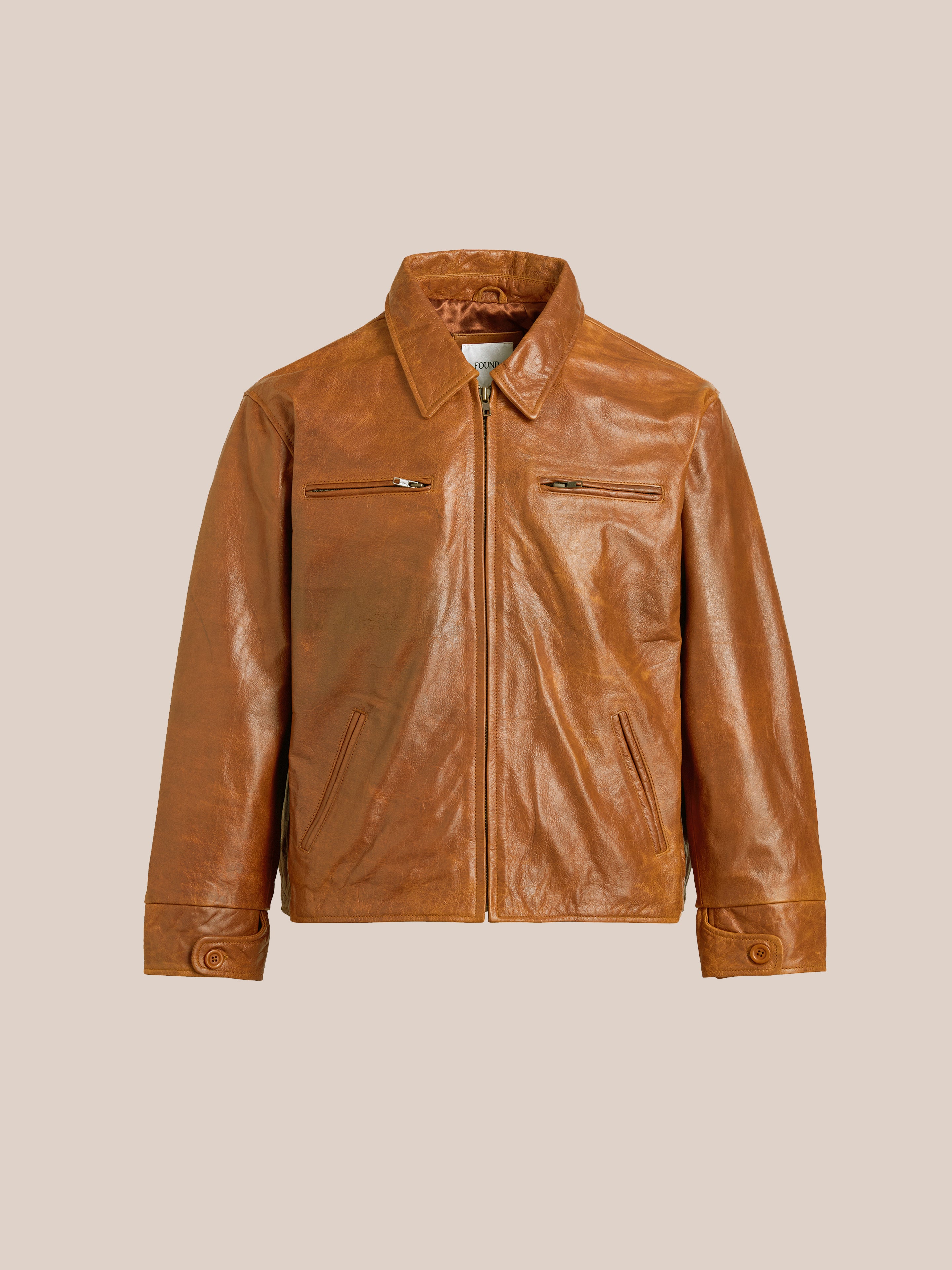 Marlboro Sun Faded Leather Racer Jacket by FOUND, featuring a brown distressed leather design with a front zipper, two chest pockets, and buttoned cuffs, set against a neutral background.