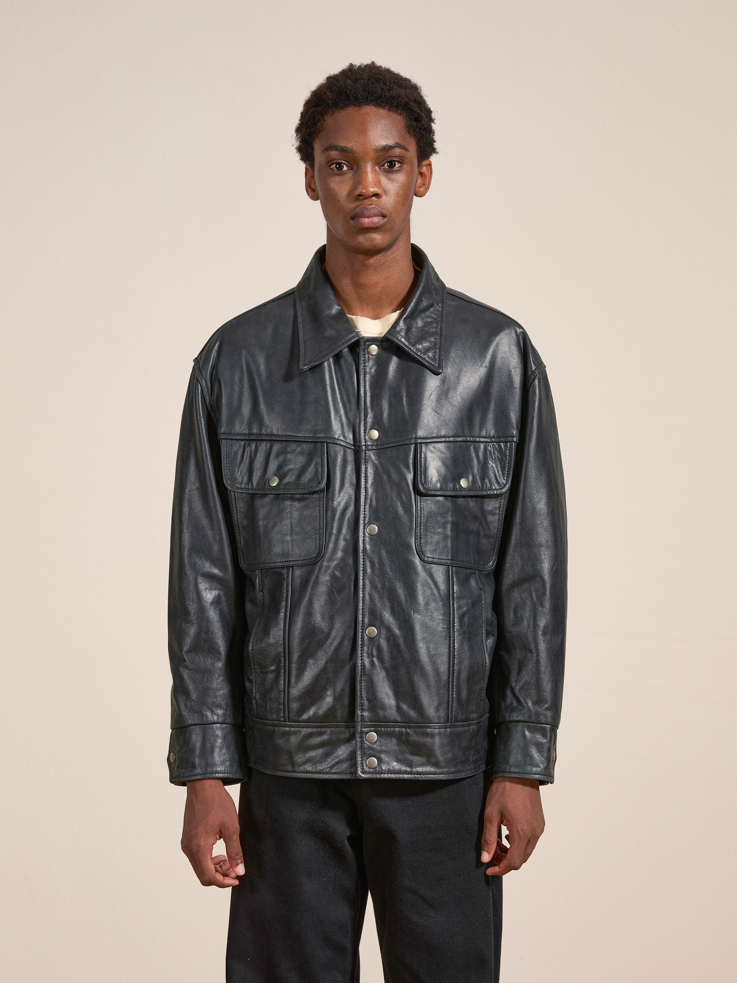 A person wearing the FOUND Leather Trucker Jacket stands against a plain background.