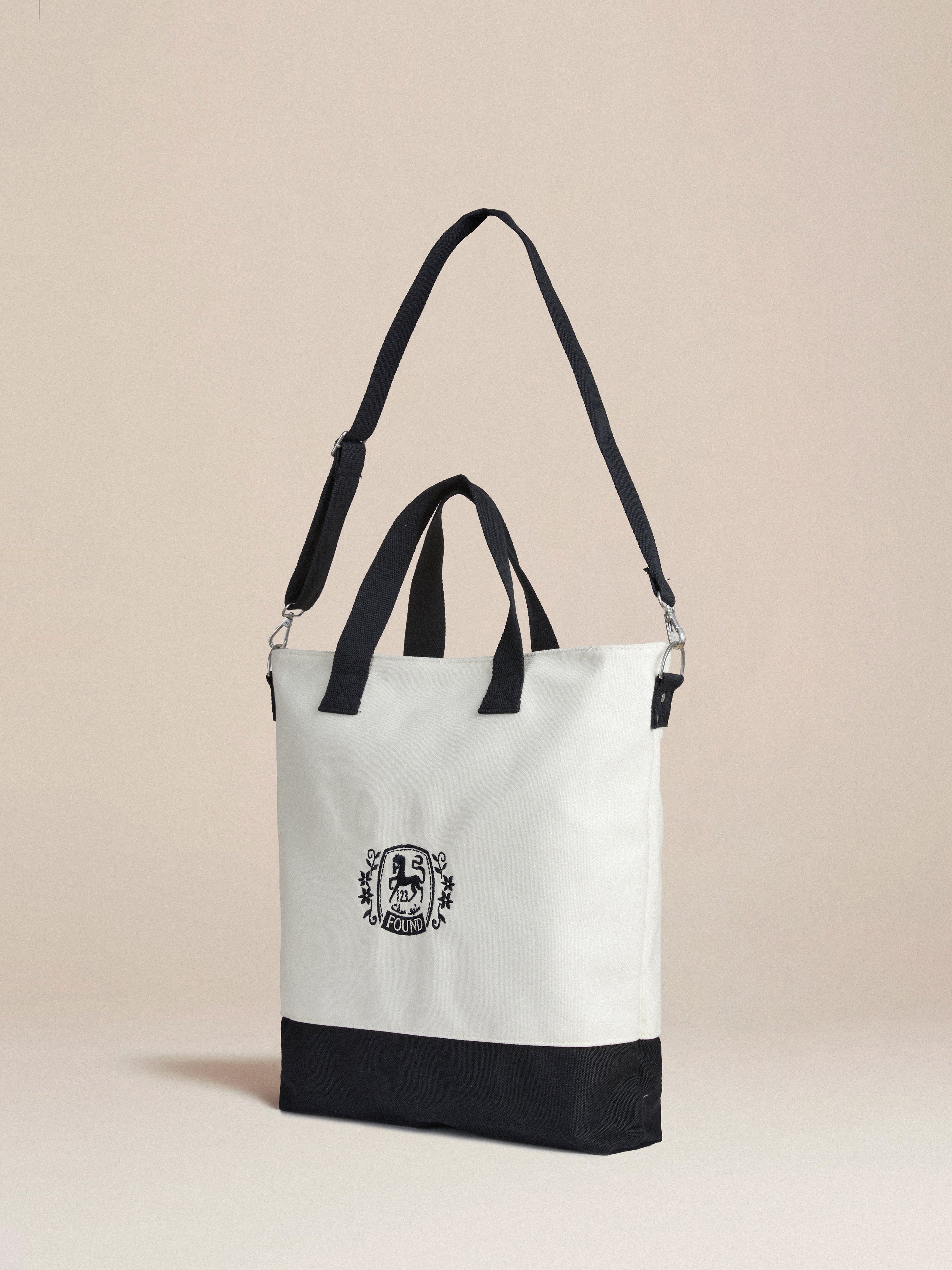 A black and white Horse Logo Crest Canvas Bag with a distinctive logo crest on it by Profound.