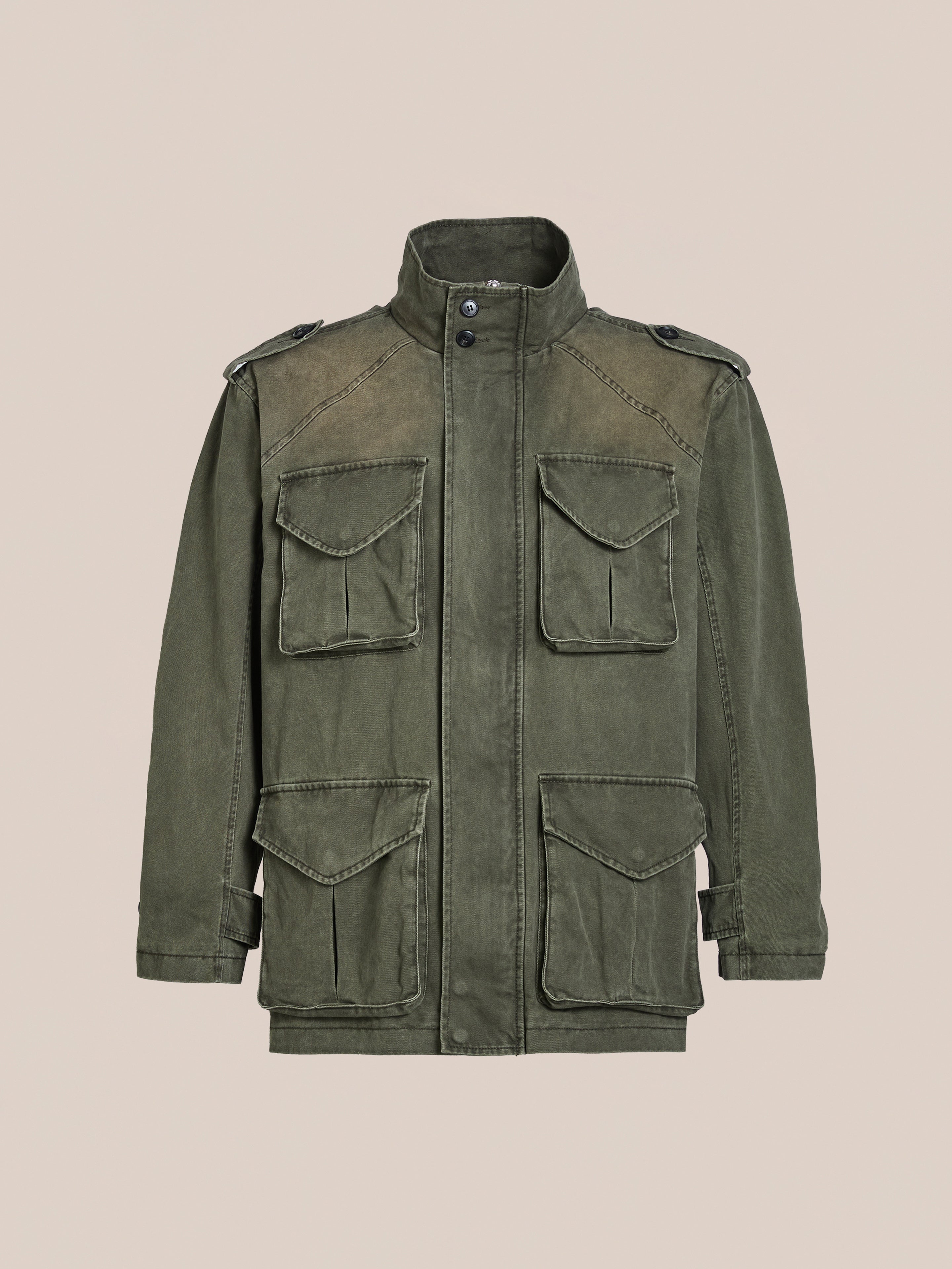 The M65 Utility Twill Pocket Jacket by FOUND comes in olive green with shoulder epaulets and four front pockets, offering a vintage style against a neutral background.