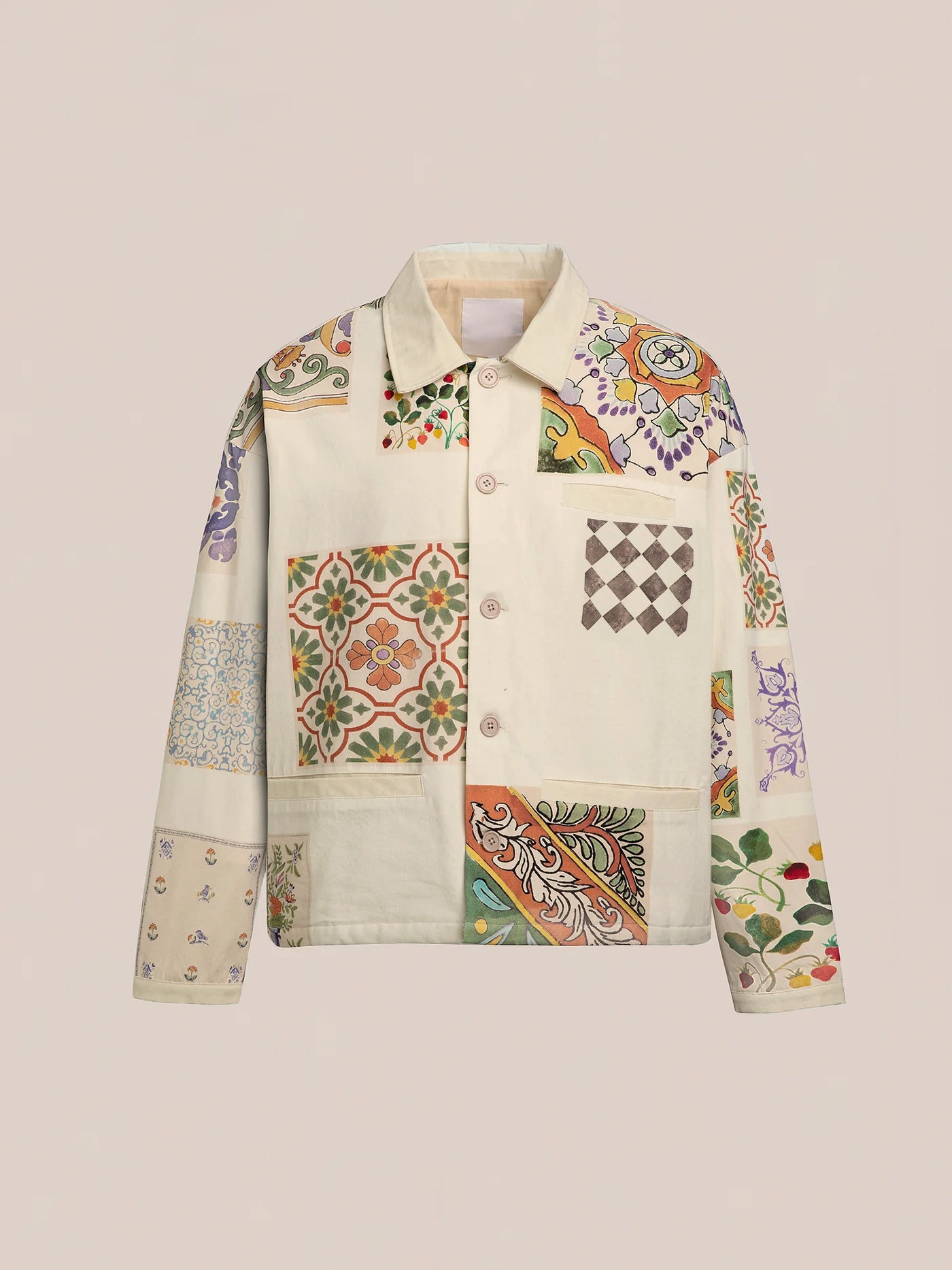 The Mosaic Work Jacket by FOUND showcases a cotton canvas fabric adorned with floral and geometric patterns inspired by Indo-Aryan designs, all set against a neutral backdrop.