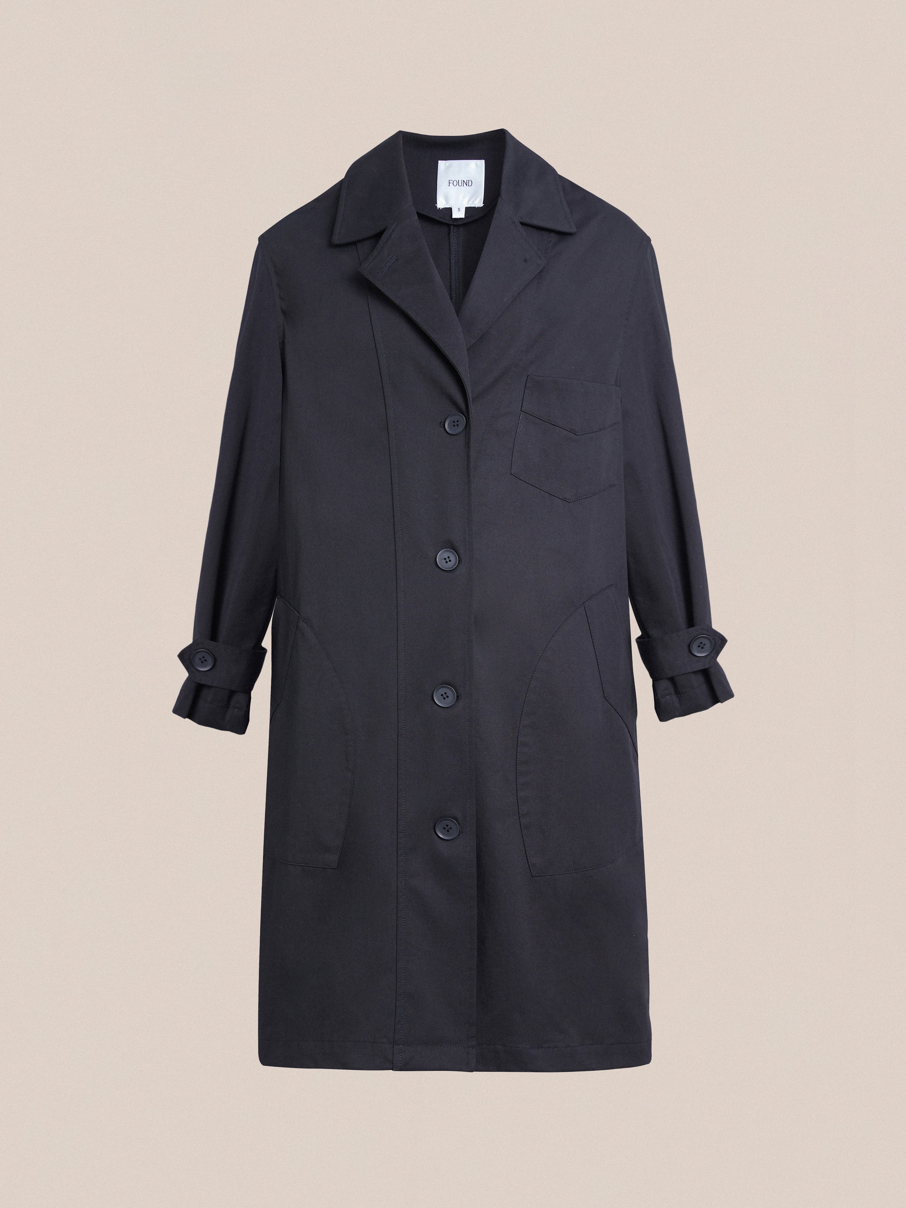 A black Found Naval Trench Coat with buttons and pockets, crafted from premium materials.