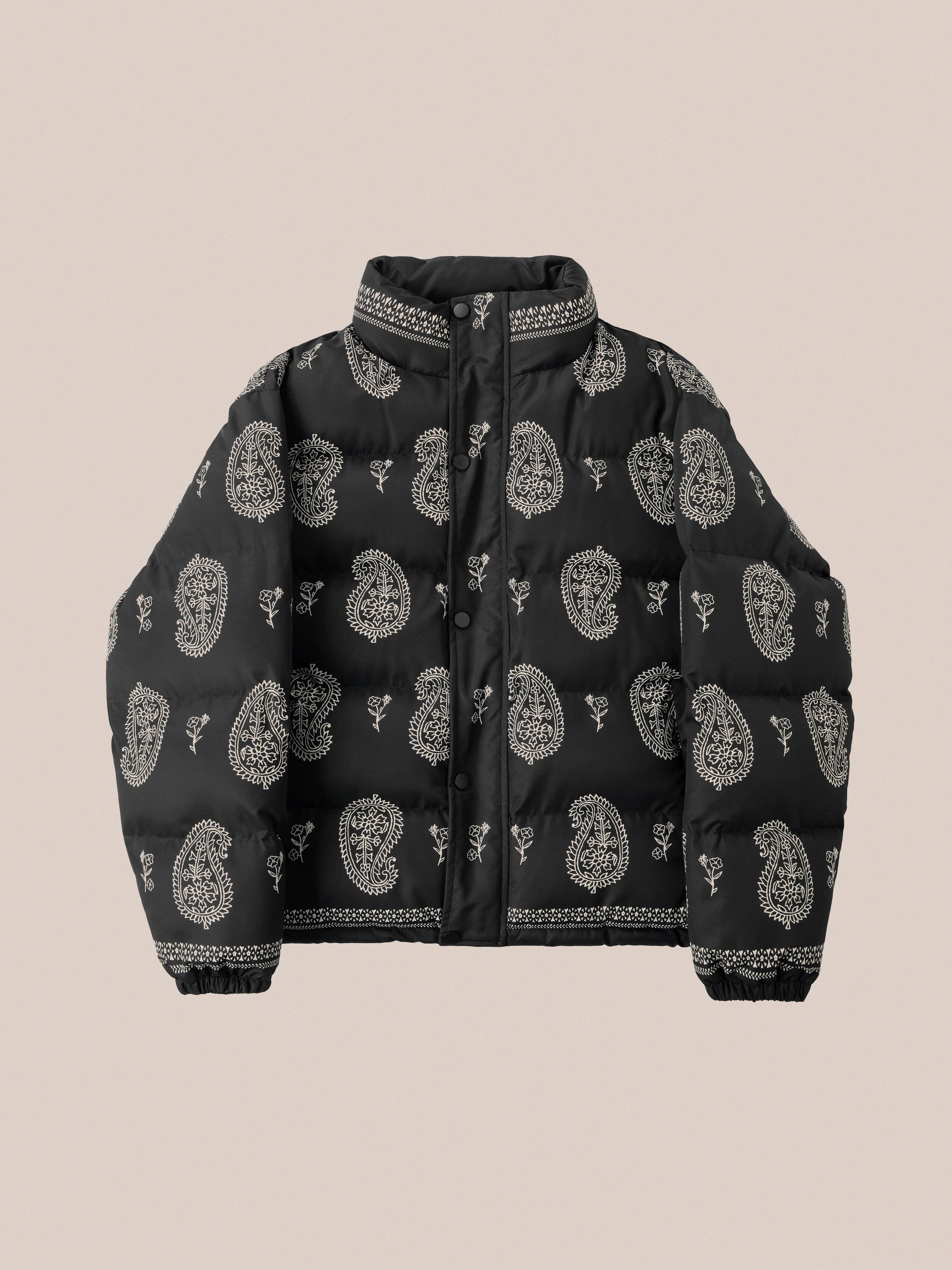 Paisley Puffer Jacket in Black from Profound, featuring a nylon shell with an eye-catching black bandana paisley pattern set against a beige background.