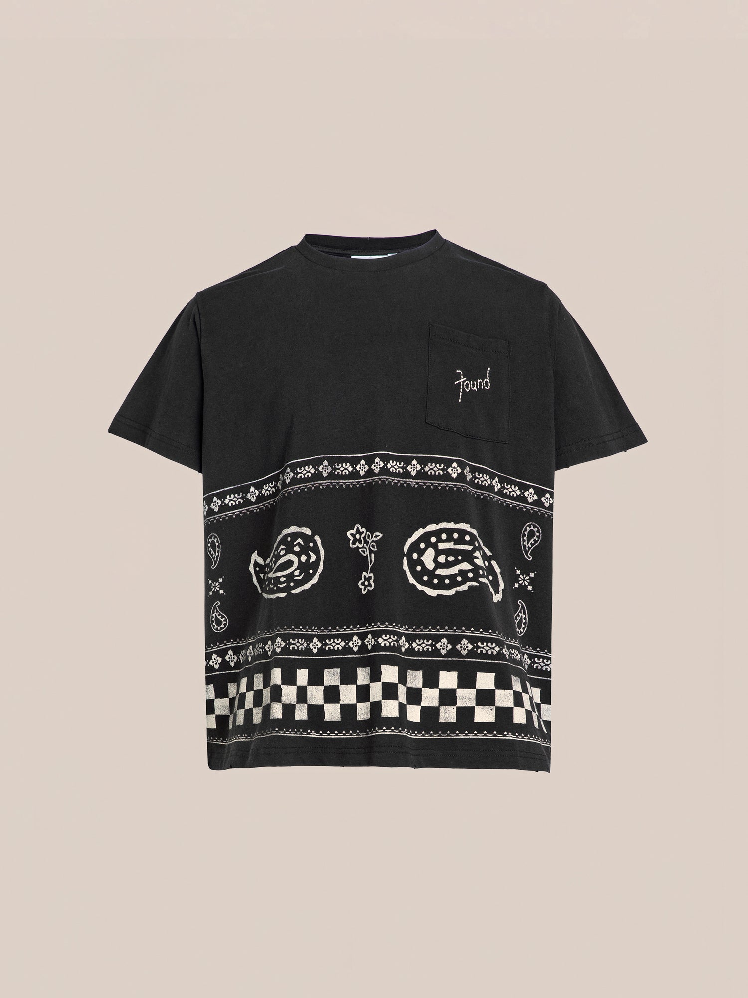 FOUND's Ornament Pocket Tee is a black t-shirt featuring a chest pocket and decorative white patterns including paisley designs and checkered stripes on the lower half.