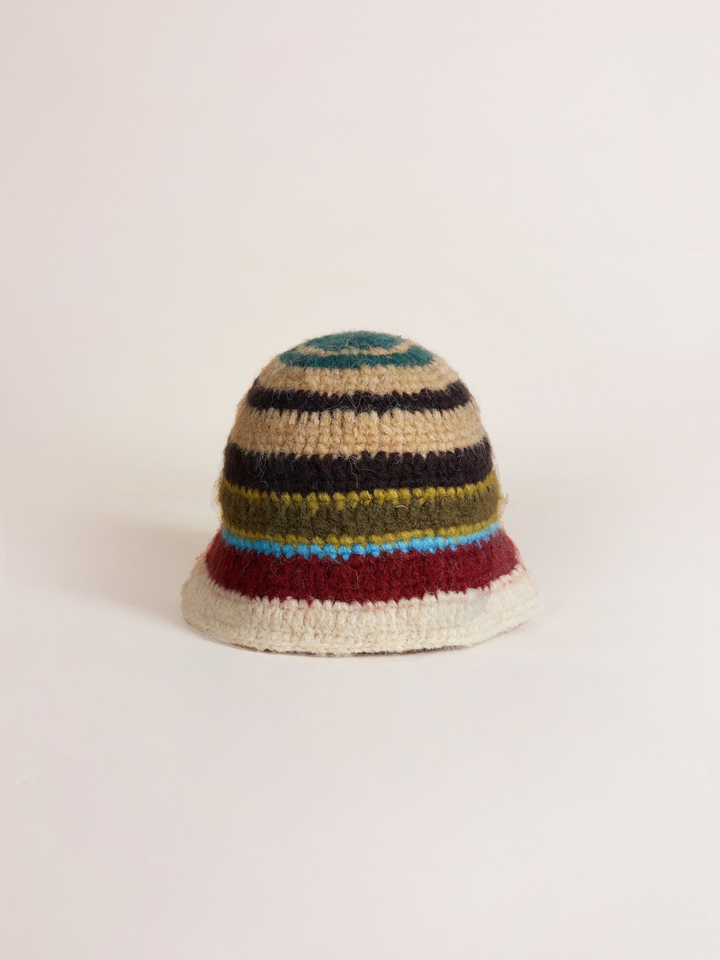 A Stripe Knit Beanie by Found, showcasing a multi-color stripe pattern in a roll-up shape, displayed against a plain, light background.