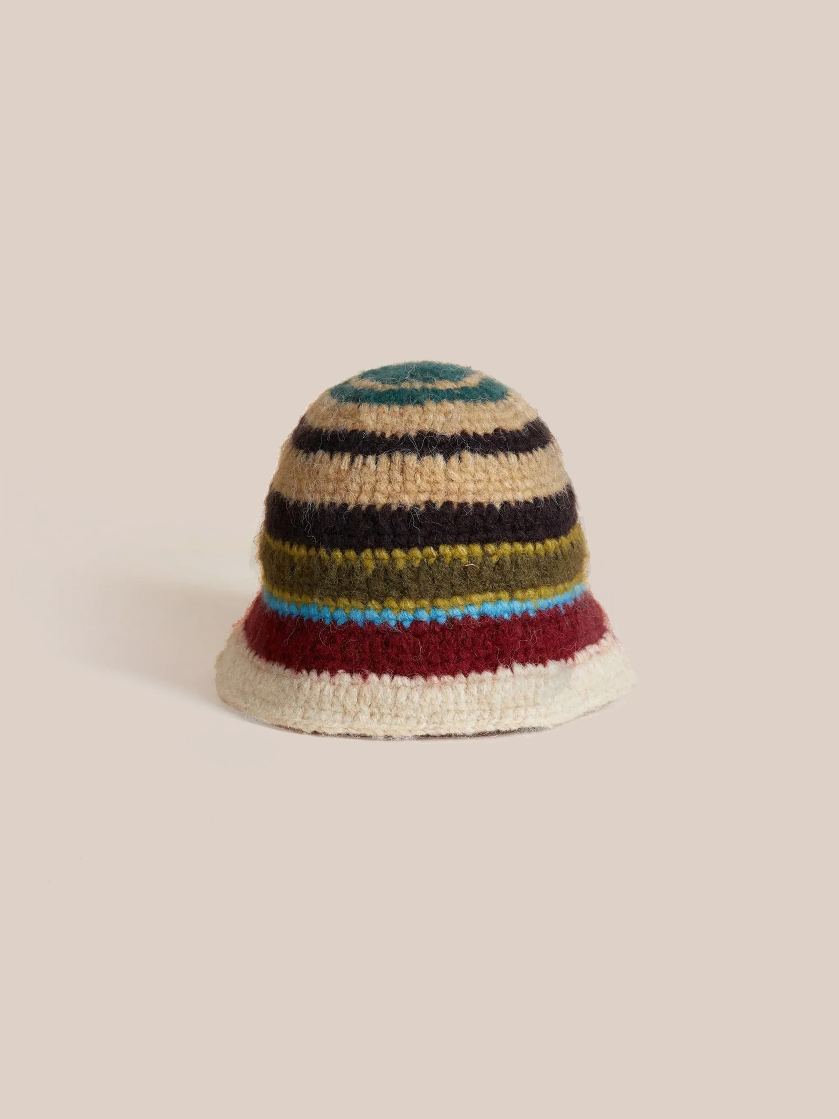 A vibrant Stripe Knit Beanie by Found, featuring a roll-up shape and multi-color stripes, rests against a plain background.