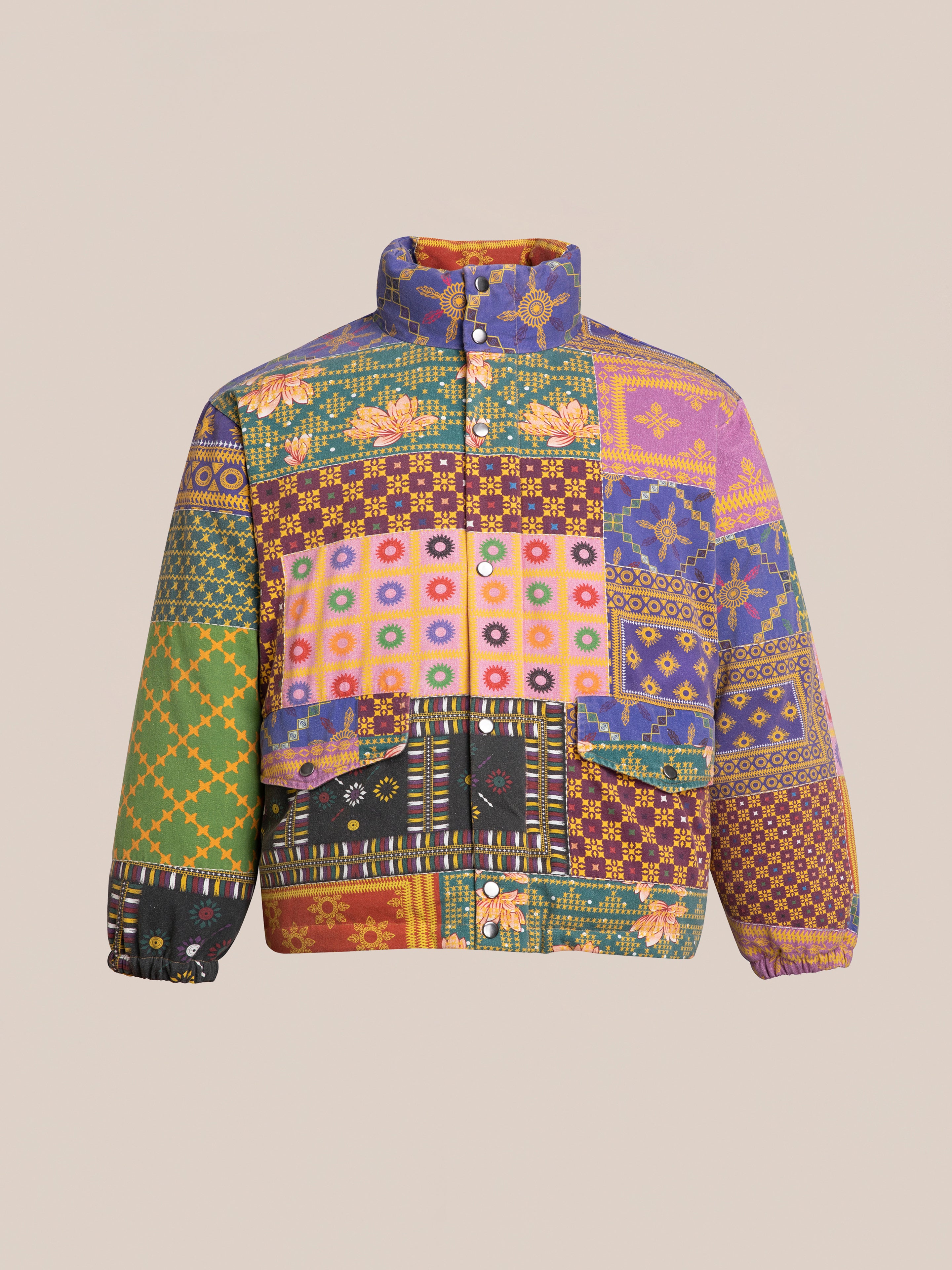 The Ayubia Printed Tapestry Puffer Jacket by FOUND features a vibrant mix of floral and geometric patterns, along with a high collar and front buttons.