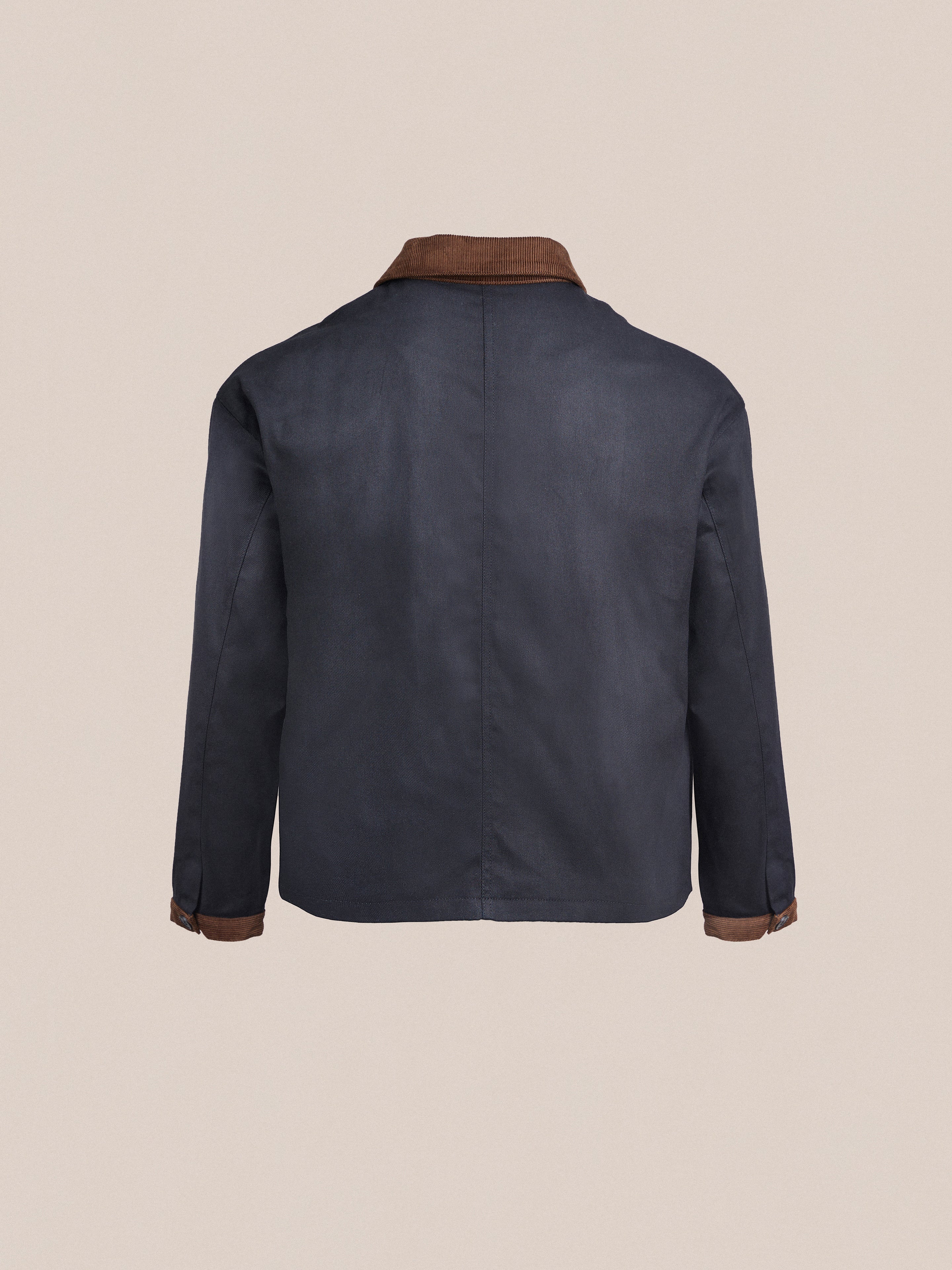 The back view of a blue Lar Waxed Cotton Box Coat with brown detailing by Found.