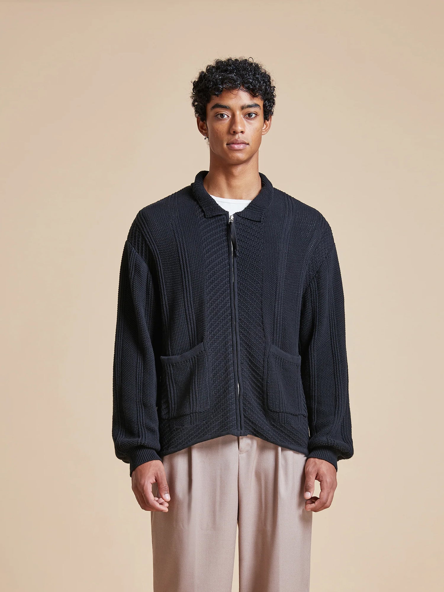The model is wearing a Found Zip Up Panel Knit Ribbed Sweater.
